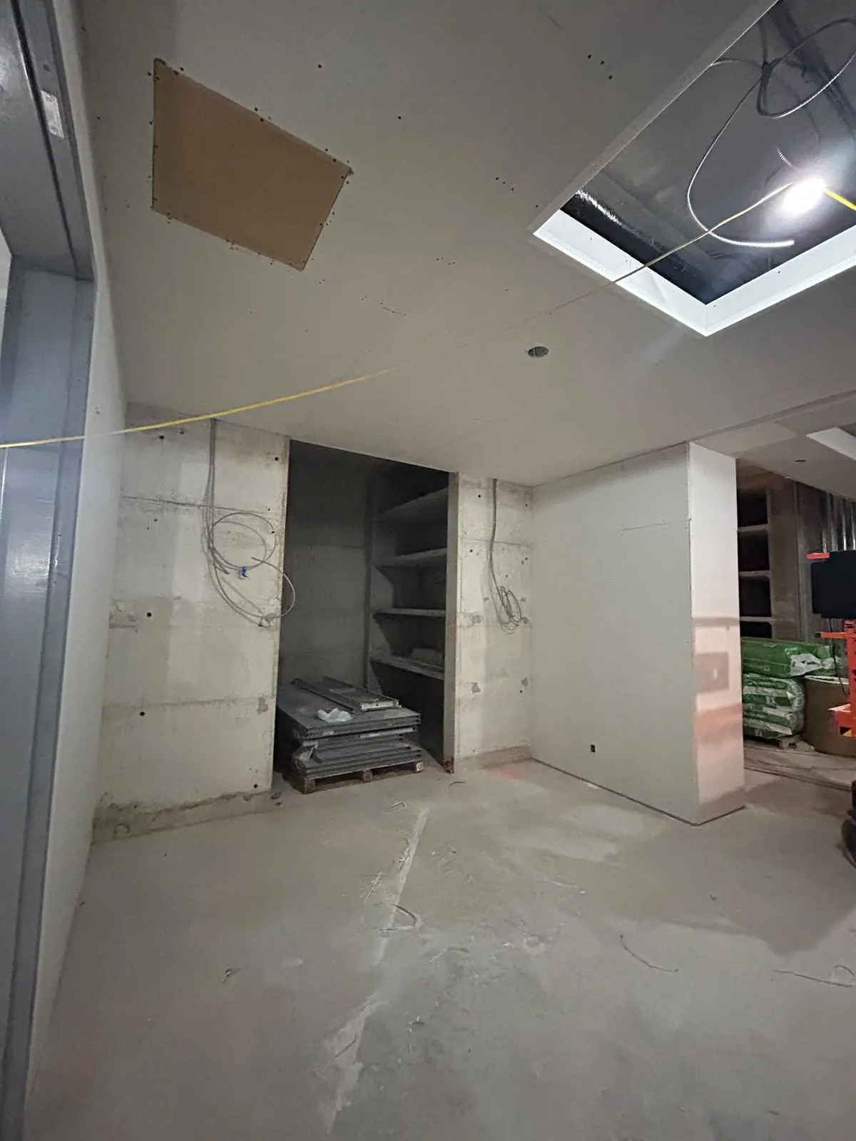 Unfinished interior with drywall ceiling, service openings and concrete walls