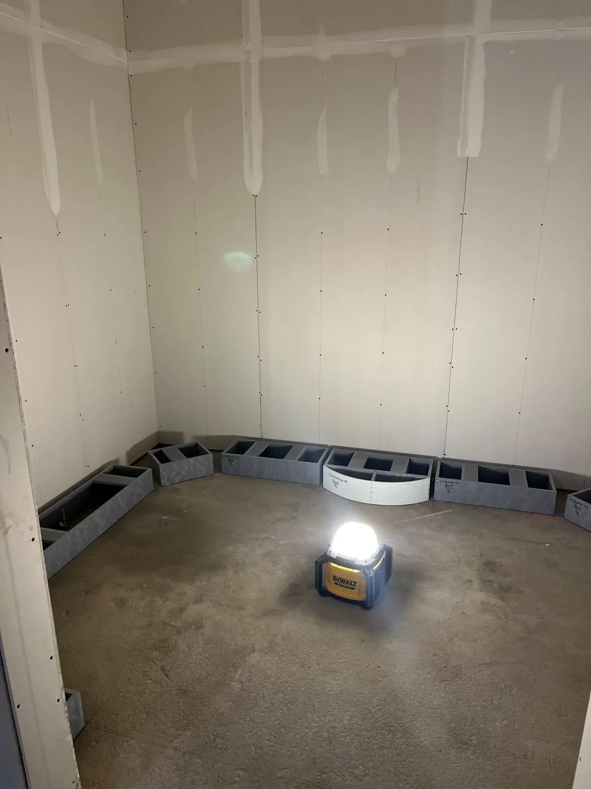Drywall panels with taped joints in an unfinished interior room